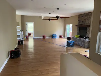 A dehumidifier drying a cleared Encino room