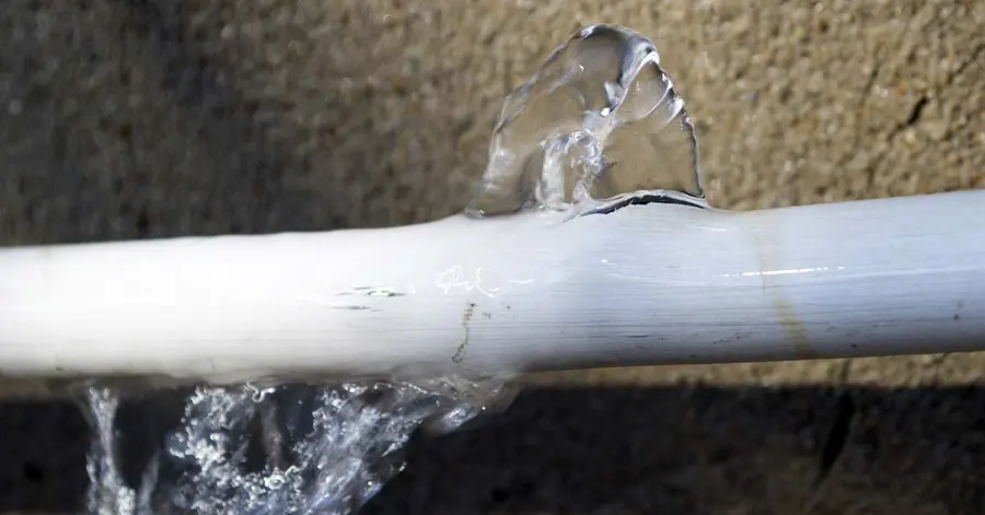 Water spreading across the floor from a burst pipe in an Encino, CA home